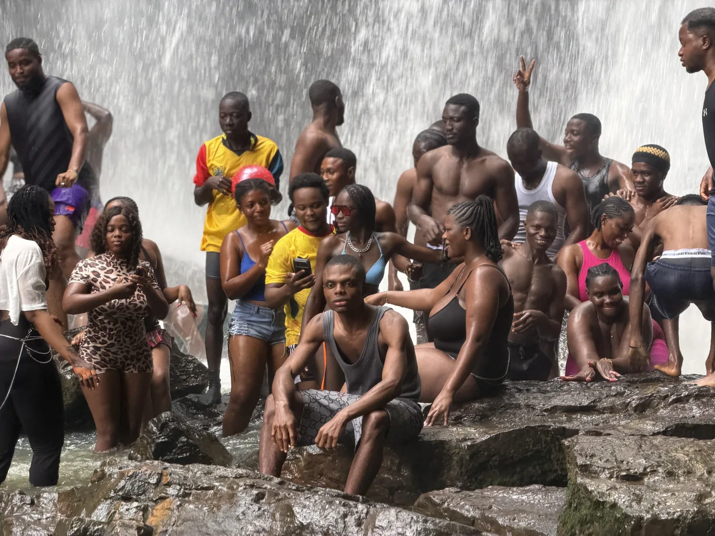 More than 50 travellers gathered in front of Oboadaka Waterfall